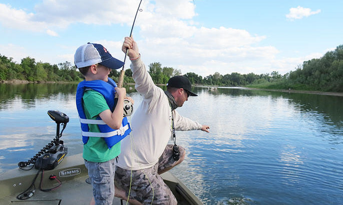 A dad fishing with his kids